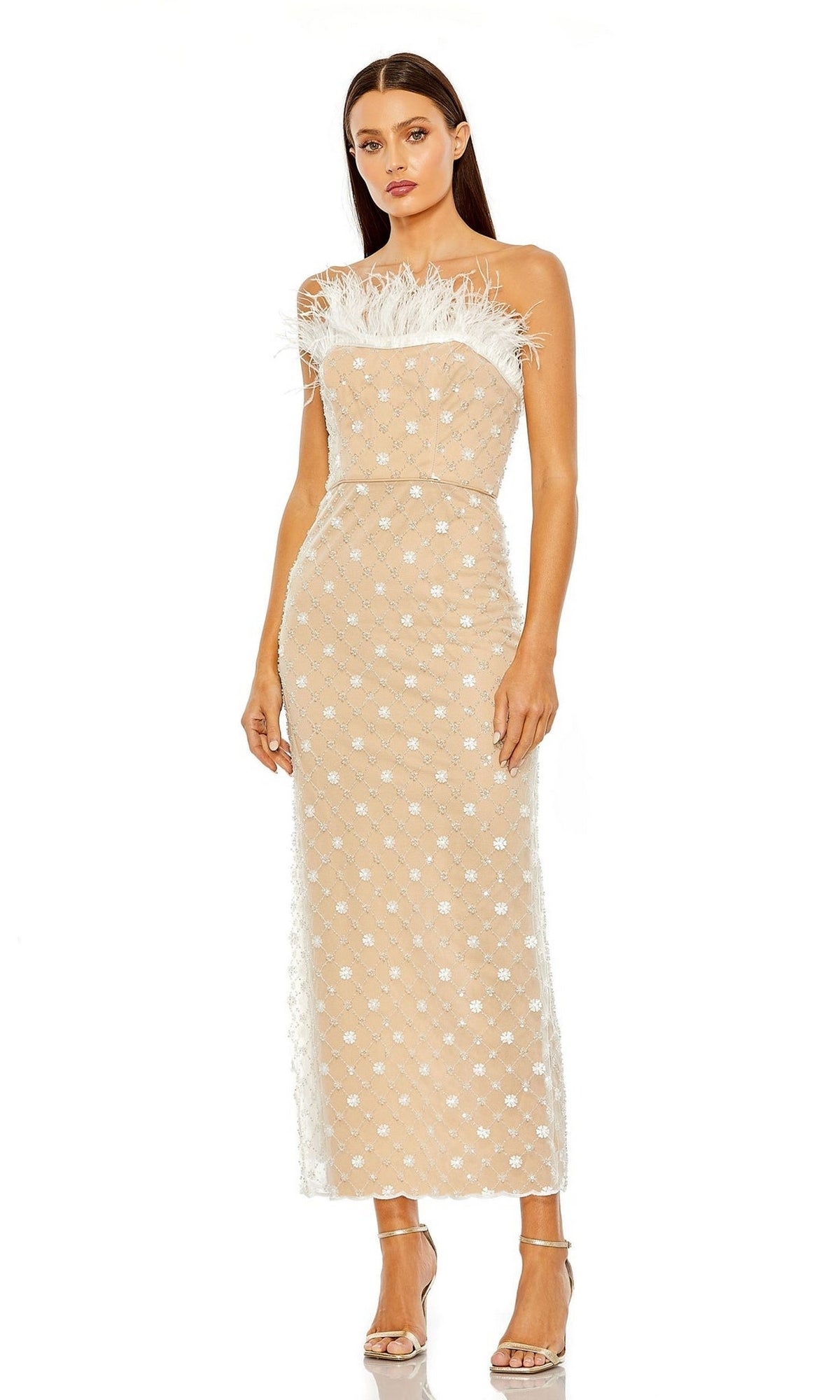 A woman wears the Mac Duggal 68140 Feather Strapless Formal Dress, a sequin-lace midi with white floral accents and feather-trimmed neckline, styled with open-toe heels for a standout party look.